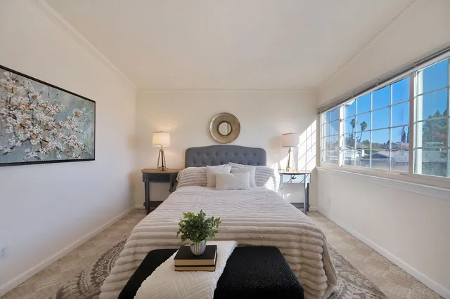 a bedroom with a large bed and a window