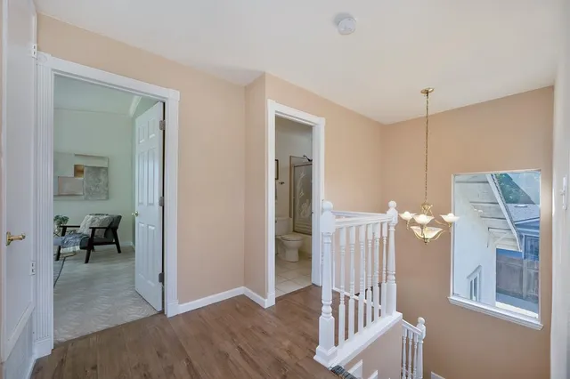 a bedroom with a bed and a potted plant