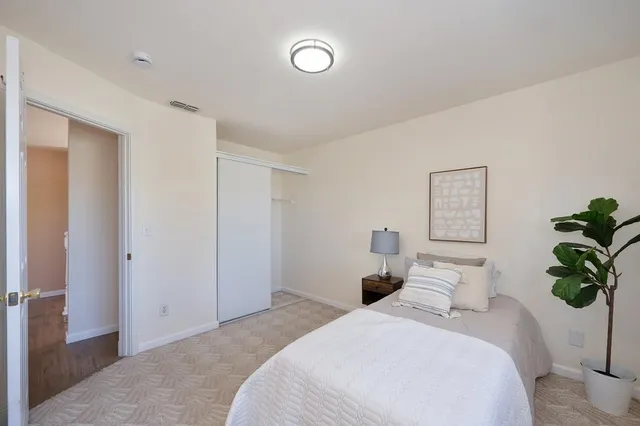 a bedroom with a bed and a window