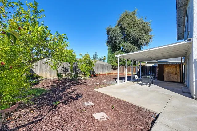 a view of a house with backyard porch and sitting area