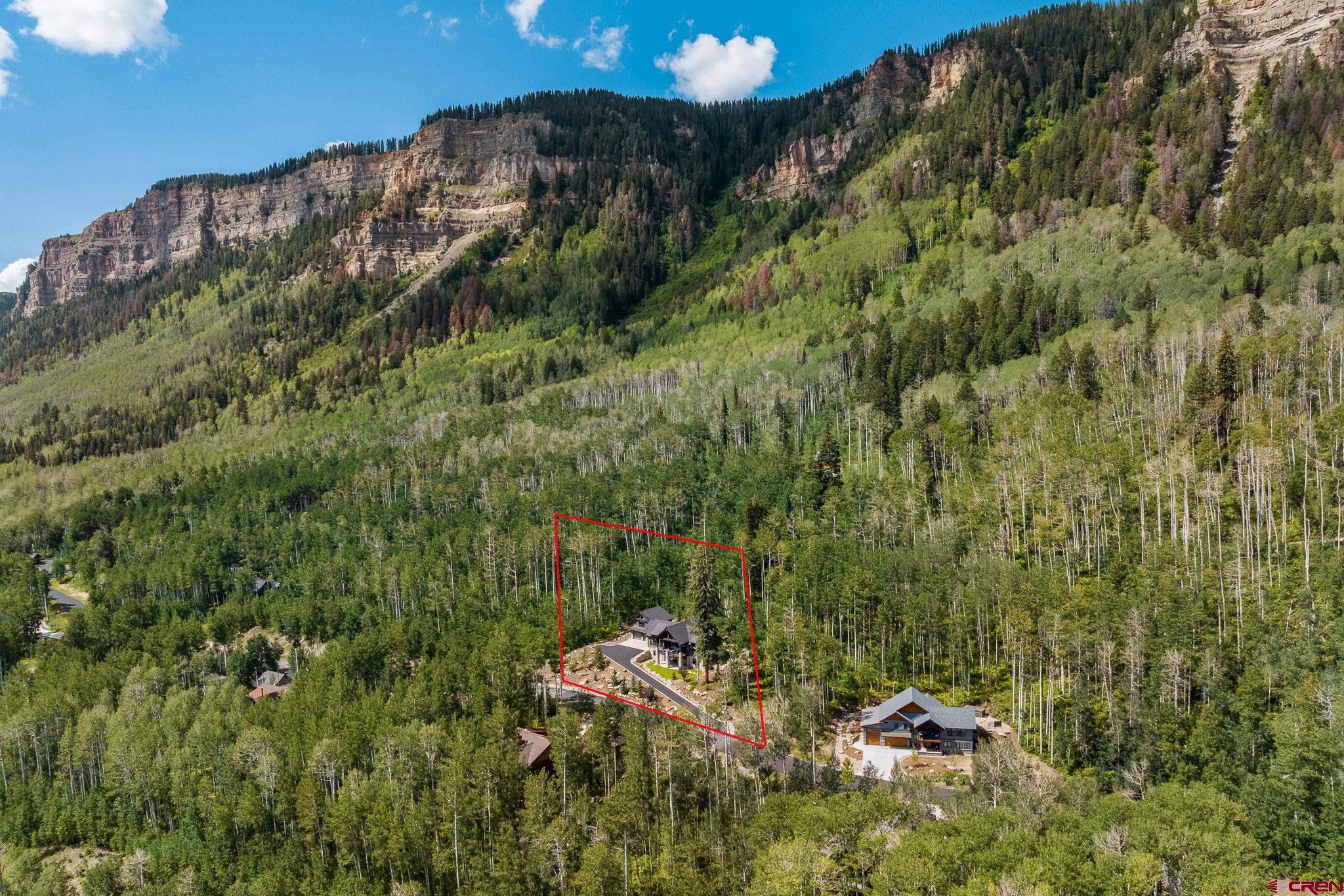 155 Long Story Road Durango, CO 81301 - Photo 16 of 45 a view of a house with a lush green forest