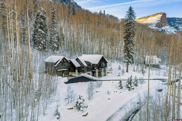 a view of a house with a yard and sitting area