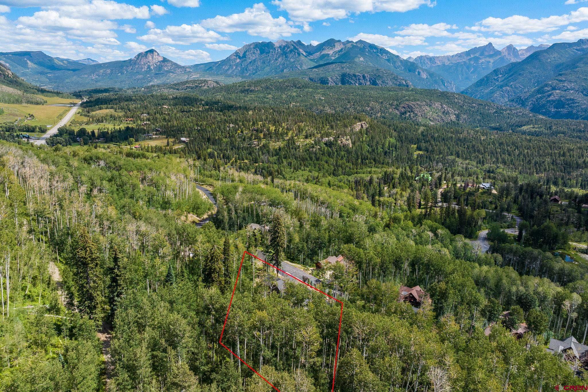 155 Long Story Road Durango, CO 81301 - Photo 23 of 45 a view of a lush green hillside and a building