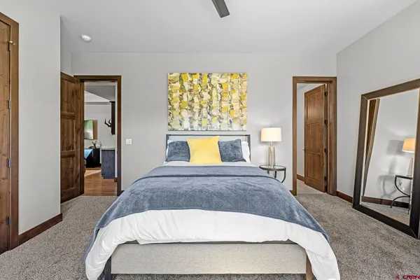 a bedroom with a bed and a large mirror