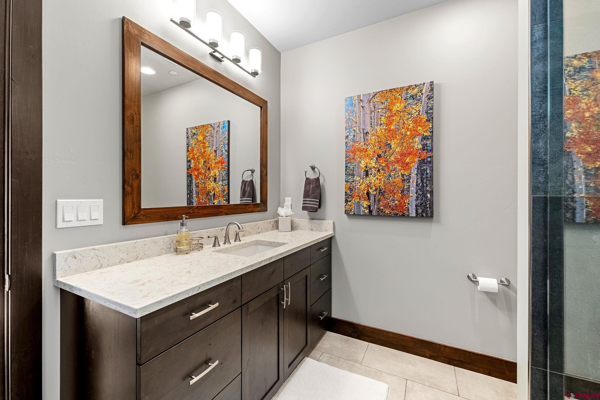 155 Long Story Road Durango, CO 81301 - Photo 27 of 45 a bathroom with a sink and a mirror