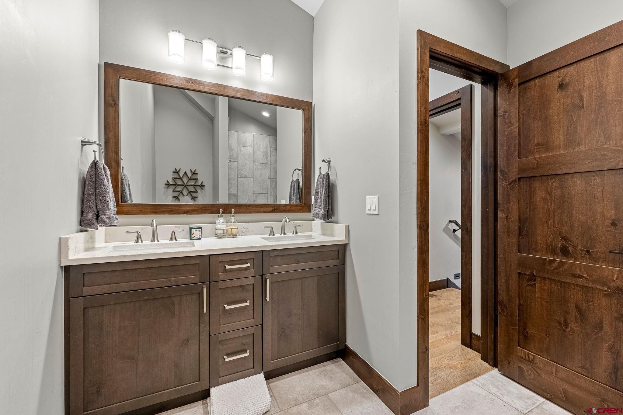 155 Long Story Road Durango, CO 81301 - Photo 30 of 45 a bathroom with a sink a mirror and a vanity