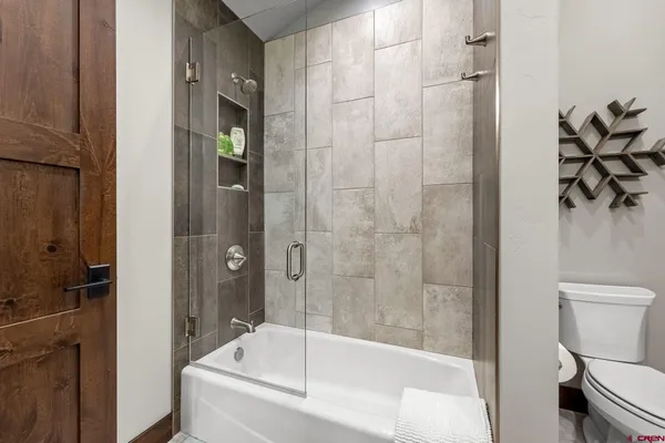 a bathroom with a bathtub and a shower