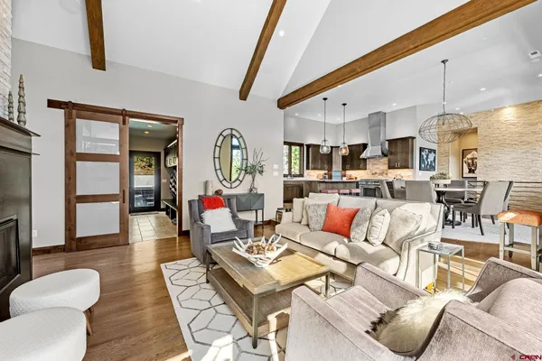 a living room with lots of furniture and kitchen view
