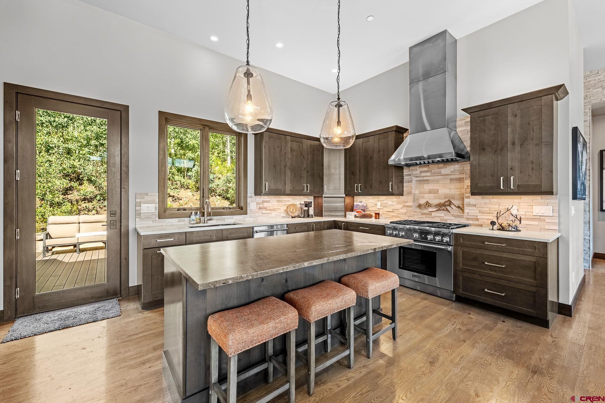 155 Long Story Road Durango, CO 81301 - Photo 36 of 45 a large kitchen with granite countertop a stove a sink and a refrigerator