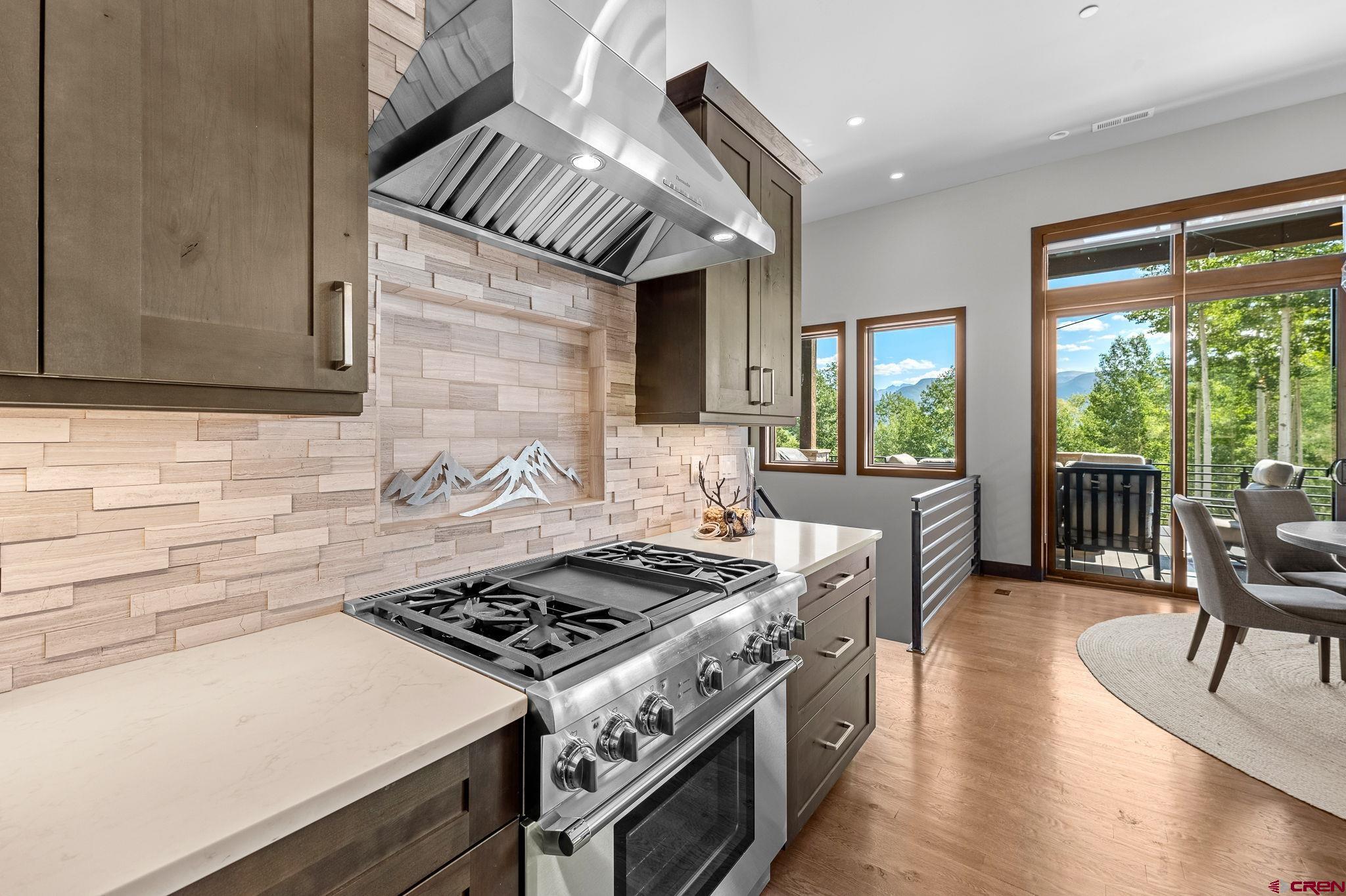 155 Long Story Road Durango, CO 81301 - Photo 38 of 45 a kitchen with a stove a sink a dining table and chairs