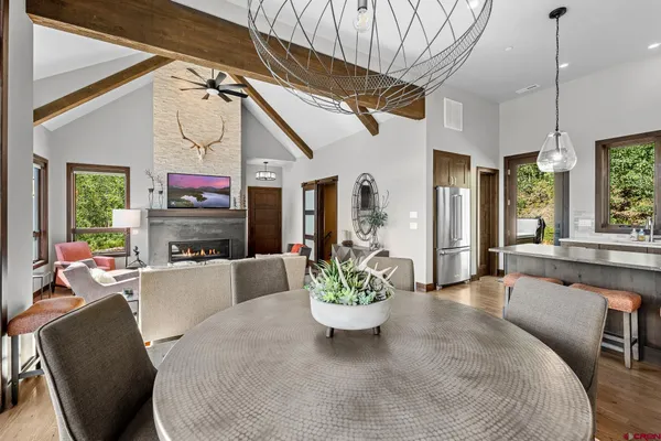 a living room with furniture a fireplace and a dining table