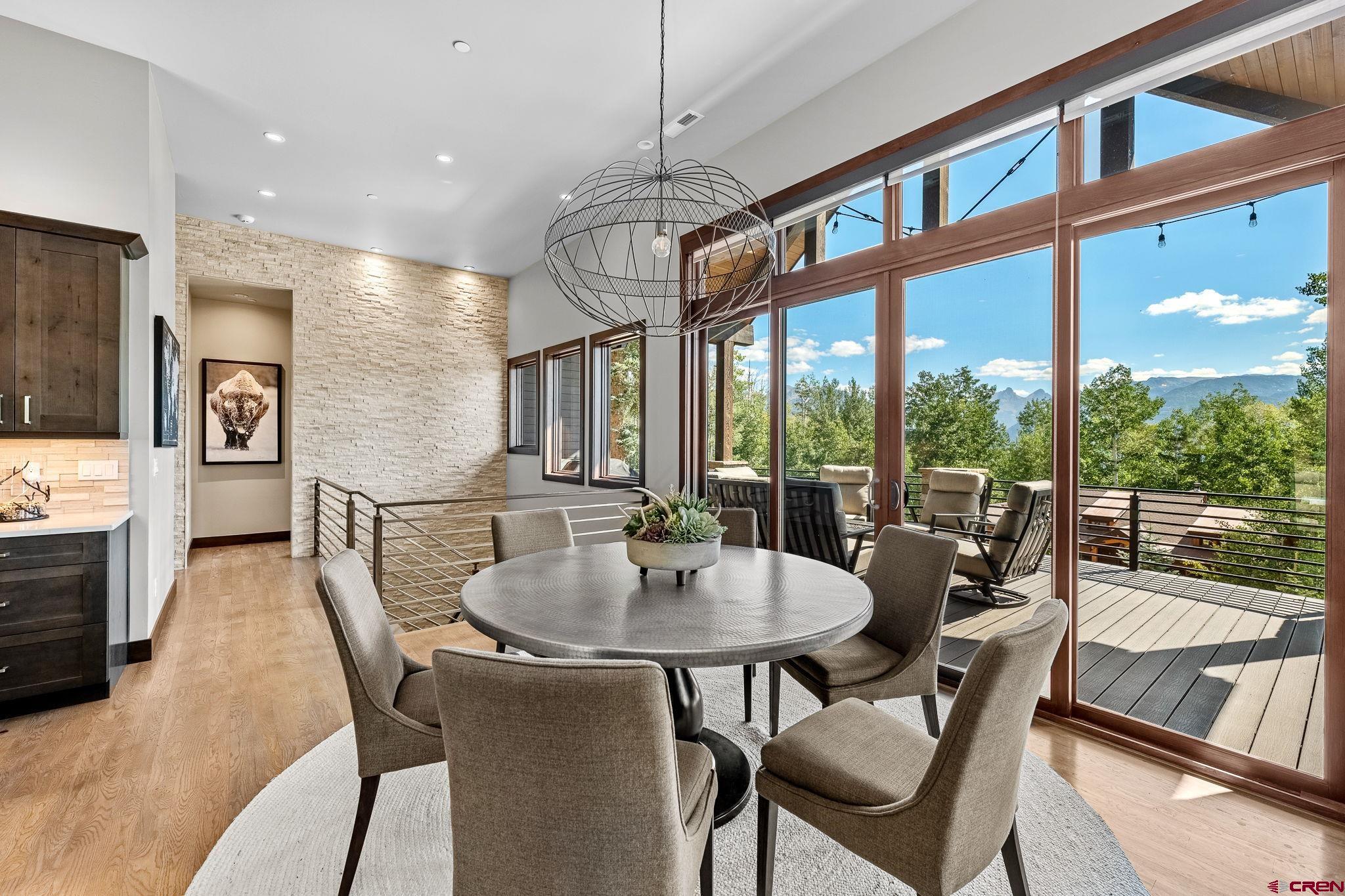 155 Long Story Road Durango, CO 81301 - Photo 40 of 45 a dining room with furniture a chandelier and wooden floor