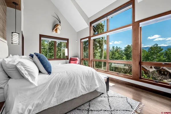 a bedroom with large bed and a large window