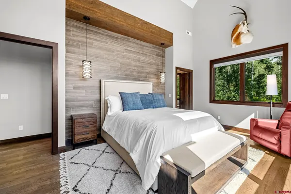 a bed sitting in a bedroom next to a window