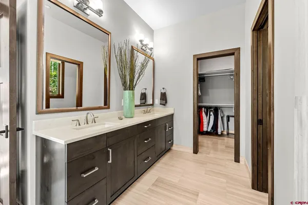 a en suite bathroom with a double vanity sink and a mirror