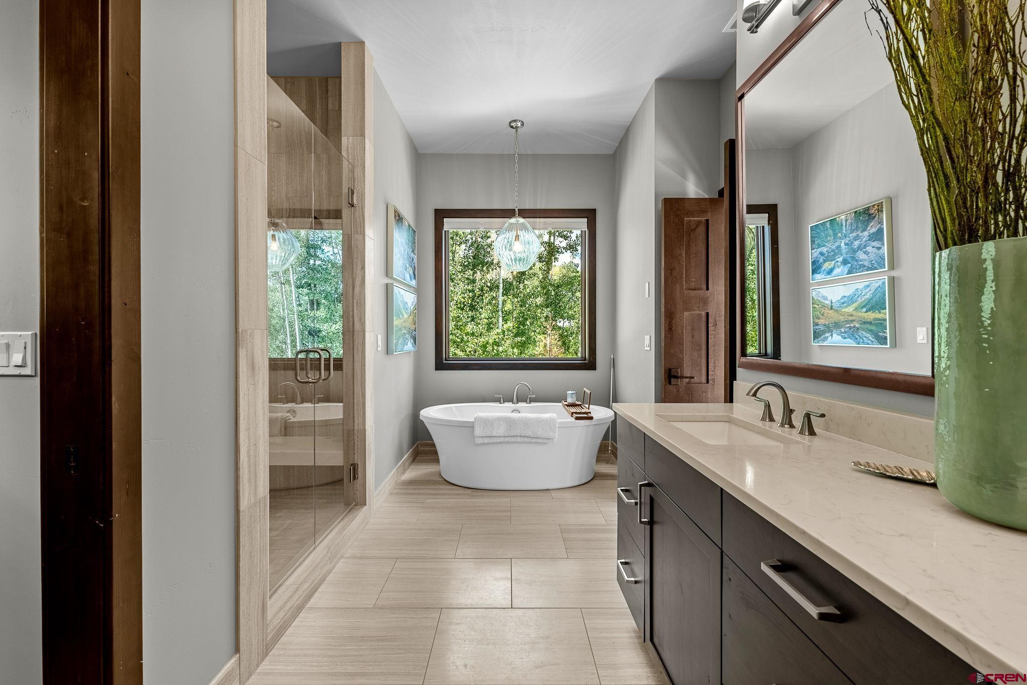155 Long Story Road Durango, CO 81301 - Photo 10 of 45 a bathroom with a granite countertop tub sink and mirror