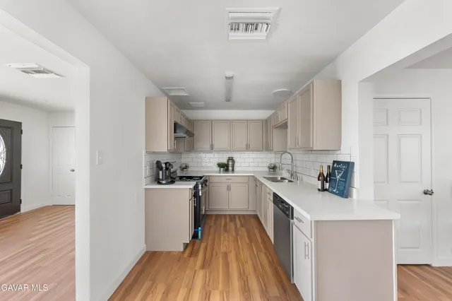 a kitchen with white cabinets and white appliances