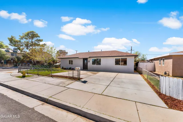 a view of a house with pool and sitting area