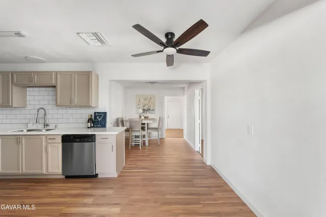 a kitchen with a sink cabinets and wooden floor