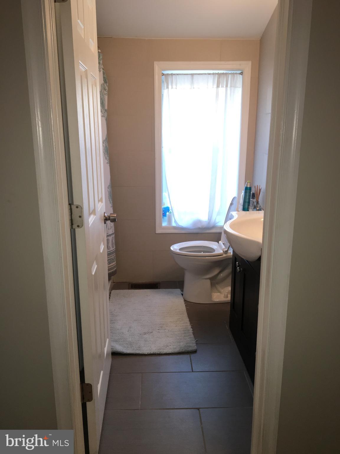 4203 Main Street, Unit 2 Philadelphia, PA 19127 - Photo 10 of 16 a bathroom with a sink toilet and shower