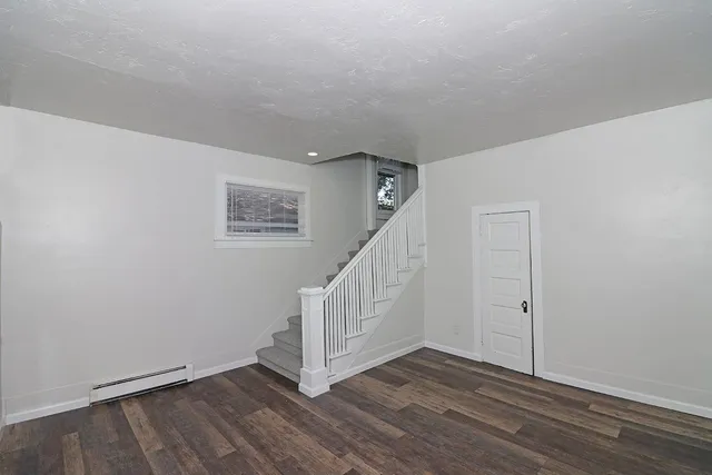 an empty room with wooden floor and closet