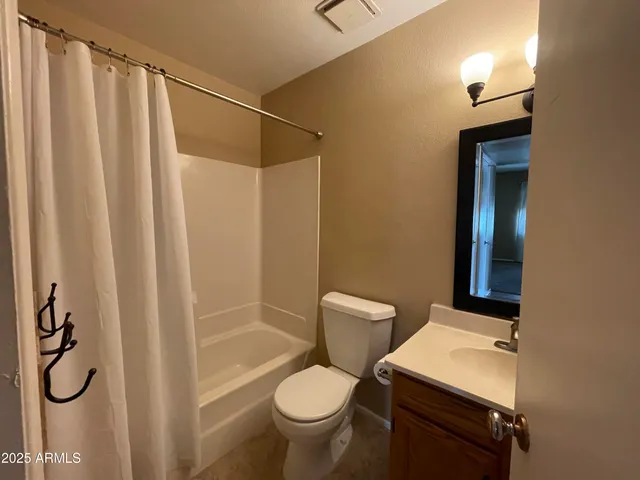 a white toilet sitting next to a bathroom sink