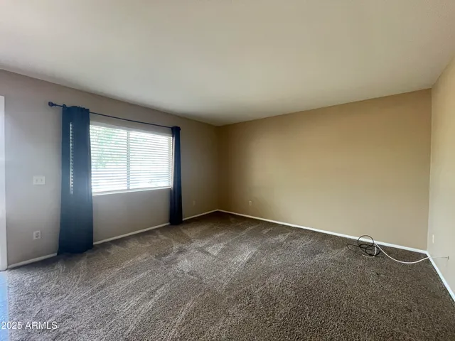 an empty room with a empty space and windows