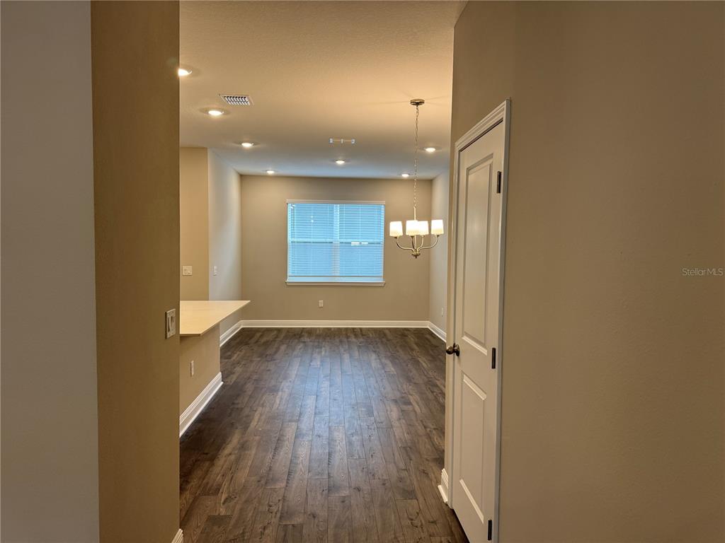 16434 Hamlin Hills Road Winter Garden, FL 34787 - Photo 8 of 50 an empty room with wooden floor and windows