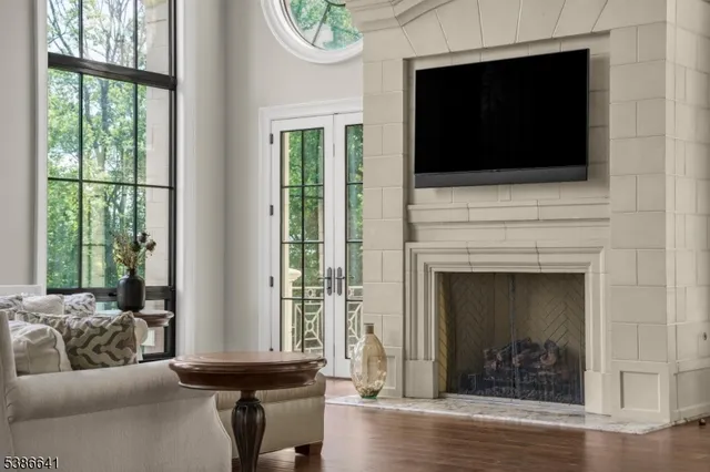 a living room with a fireplace and a flat screen tv