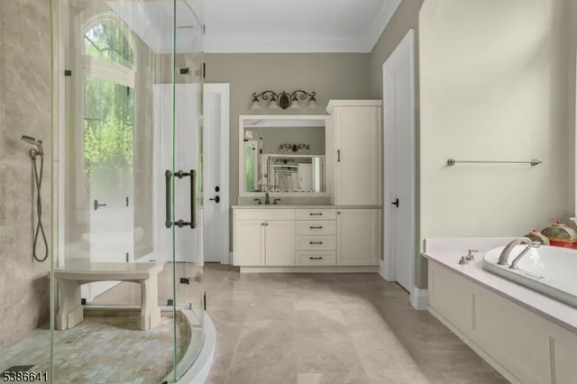 a bathroom with a tub shower sink and mirror