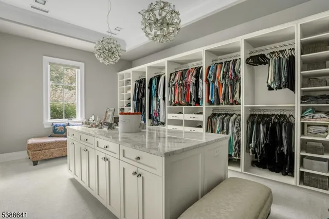 a kitchen that has a lot of cabinets and wooden floor