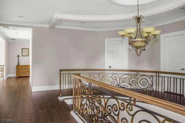 a view of a hallway with wooden floor and windows