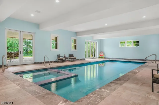 a view of a kitchen with kitchen island a large window a sink and a counter top space