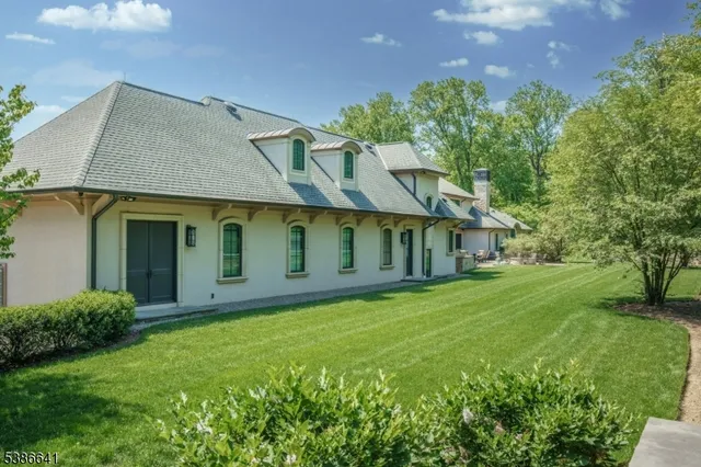 a view of a patio with table and chairs potted plants and a large tree