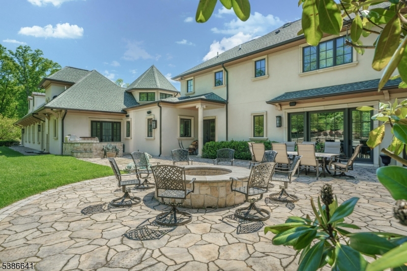 4 Mason Hill Road Warren, NJ 07059 - Photo 50 of 50 a view of a patio with table and chairs potted plants and a large tree