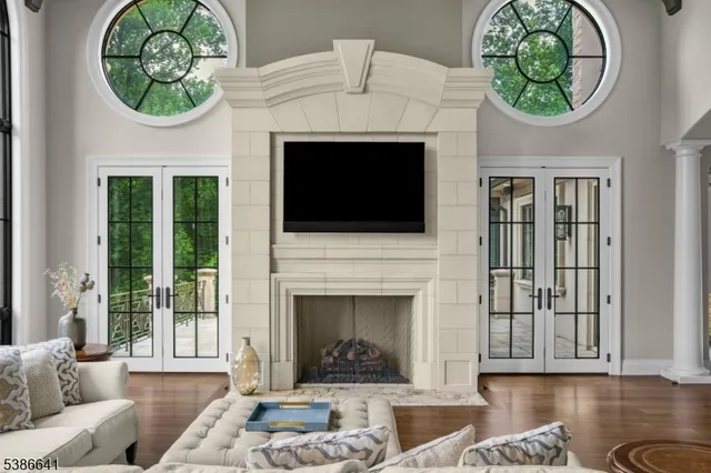 a living room with a fireplace a rug and a fireplace