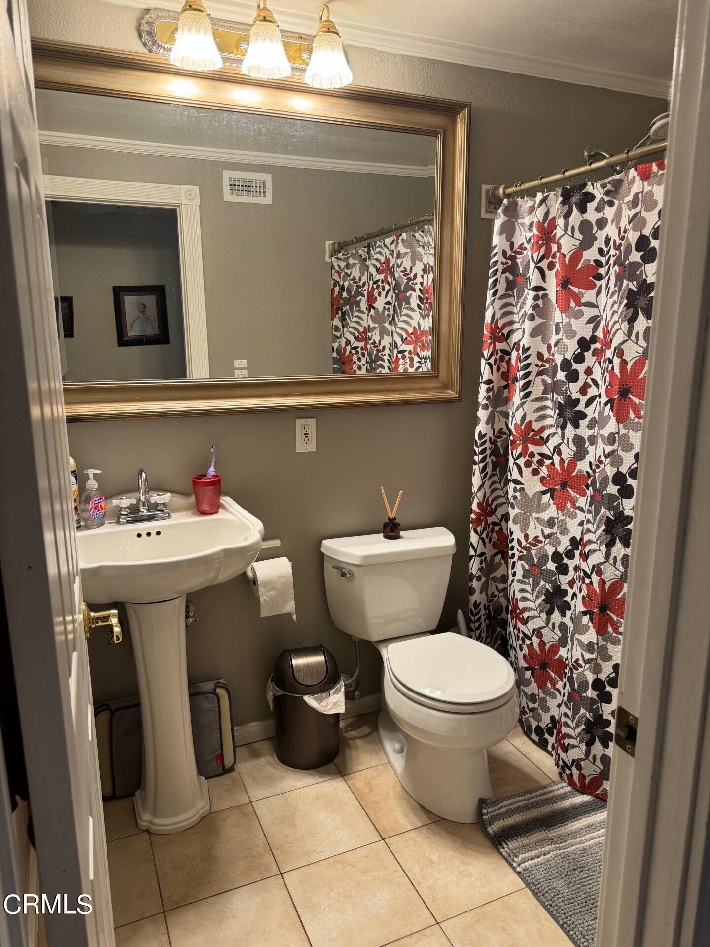 2193 Rhoda Street Simi Valley, CA 93065 - Photo 6 of 11 a bathroom with a toilet sink and mirror