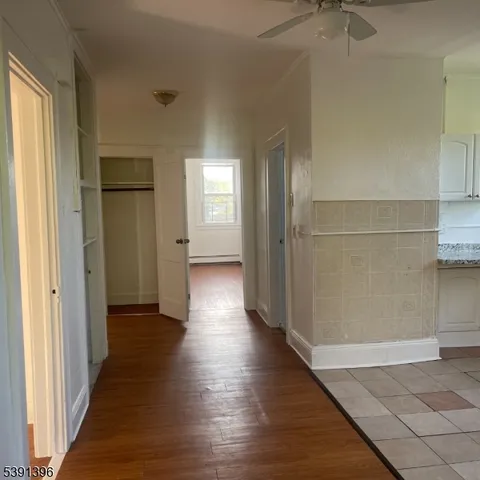 a view of a hallway with wooden floor