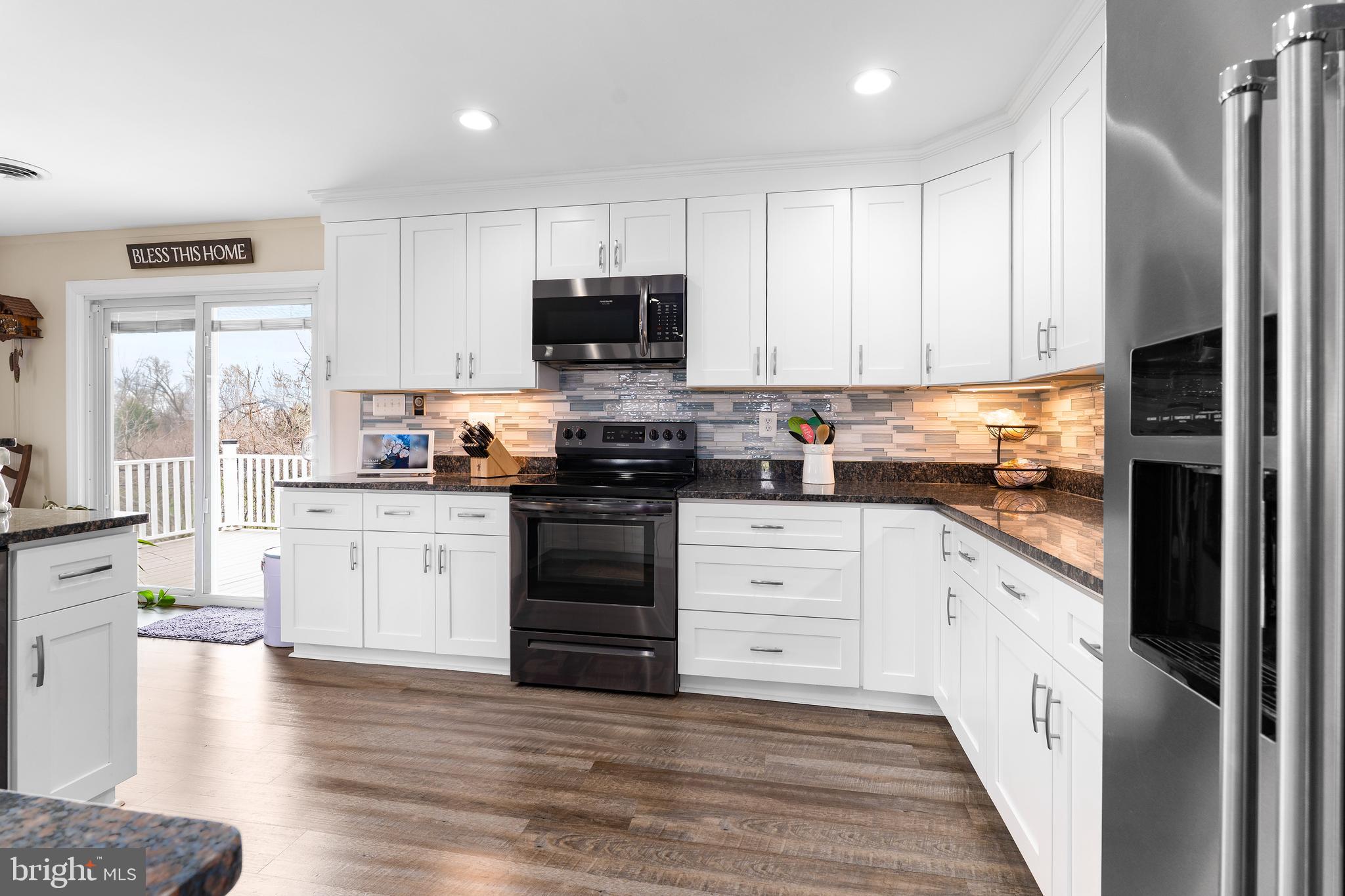 144 Bill Leight Road Conowingo, MD 21918 - Photo 10 of 28 a kitchen with stainless steel appliances a stove a sink and a refrigerator
