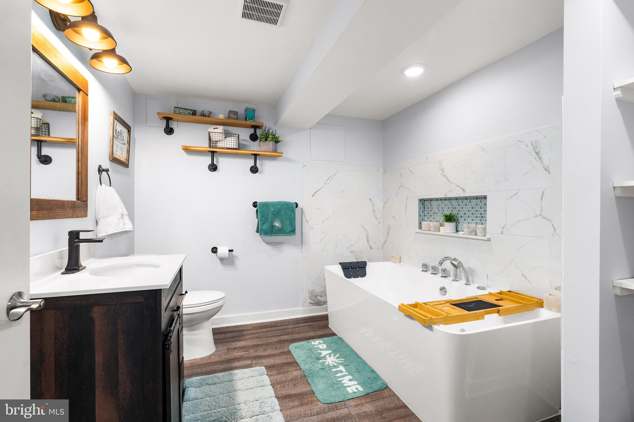 144 Bill Leight Road Conowingo, MD 21918 - Photo 18 of 28 a bathroom with a tub sink and mirror