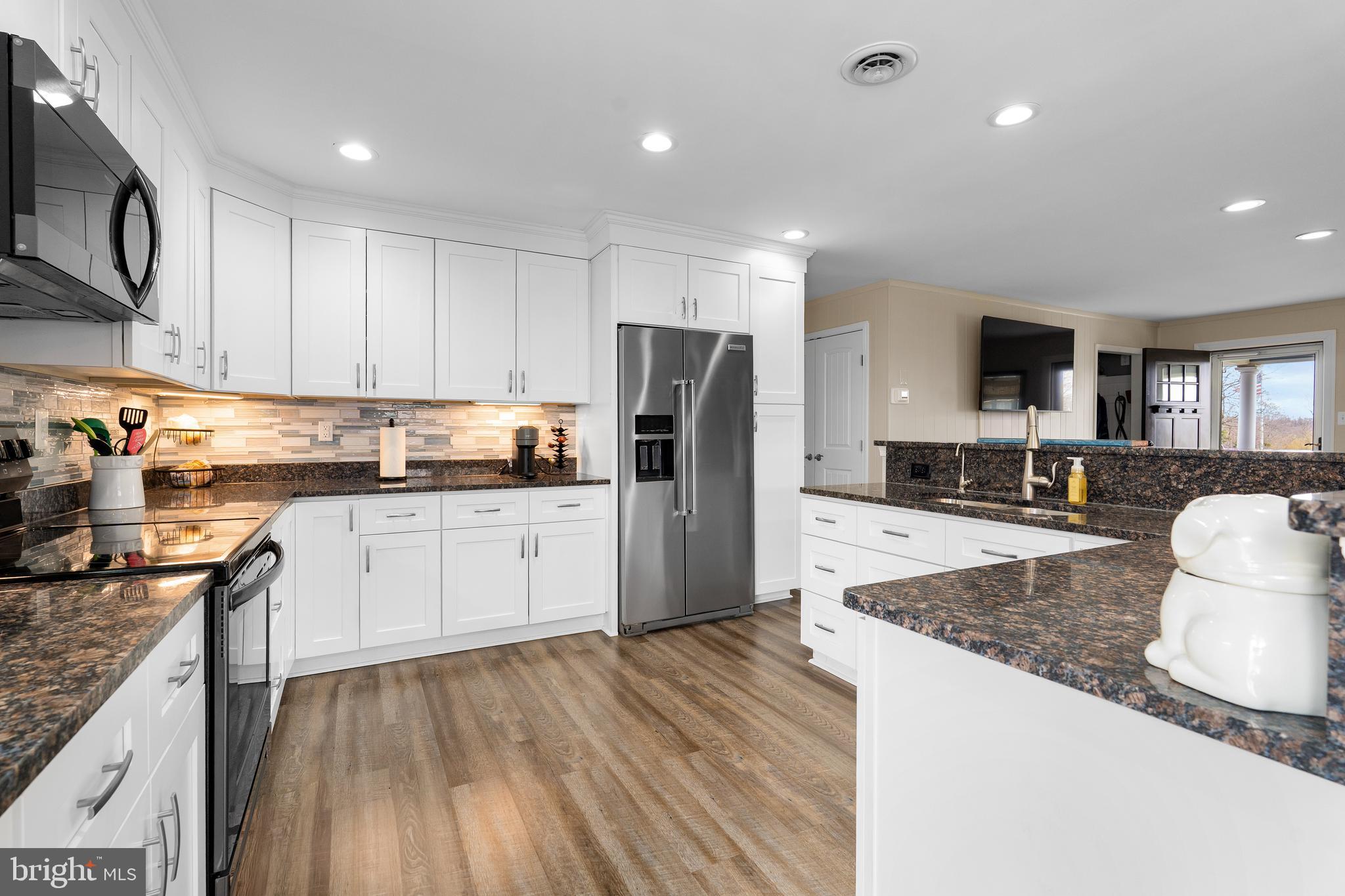 144 Bill Leight Road Conowingo, MD 21918 - Photo 9 of 28 a kitchen with stainless steel appliances granite countertop a refrigerator sink and cabinets