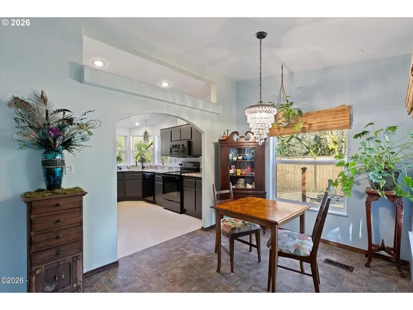 a view of a dining room with furniture and a chandelier