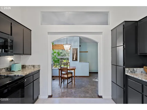 a kitchen with a refrigerator and a dining table