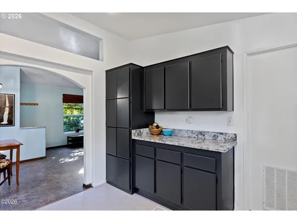 a kitchen with a sink a refrigerator and cabinets