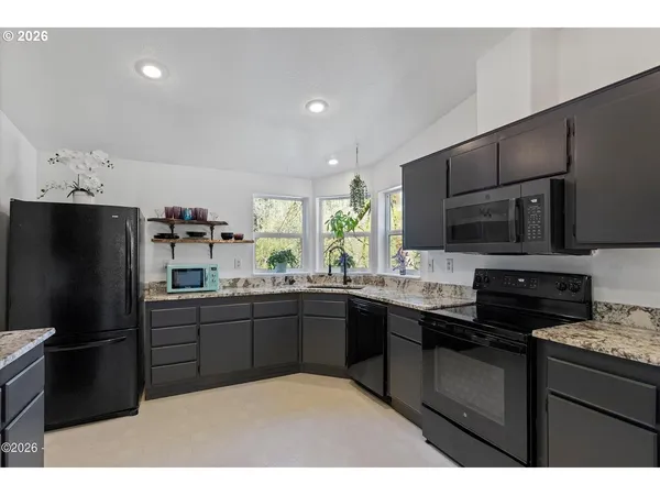 a kitchen with a sink stainless steel appliances and cabinets