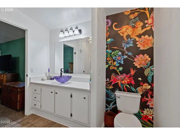 a bathroom with a sink mirror and vanity