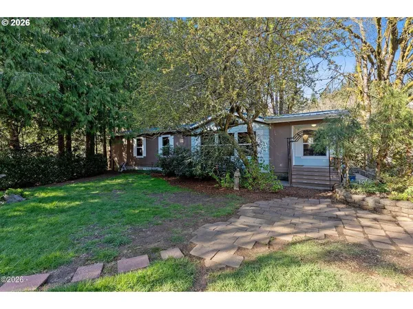 a view of a house with a yard and tree