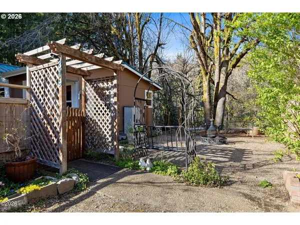 a view of a house with a yard and sitting area
