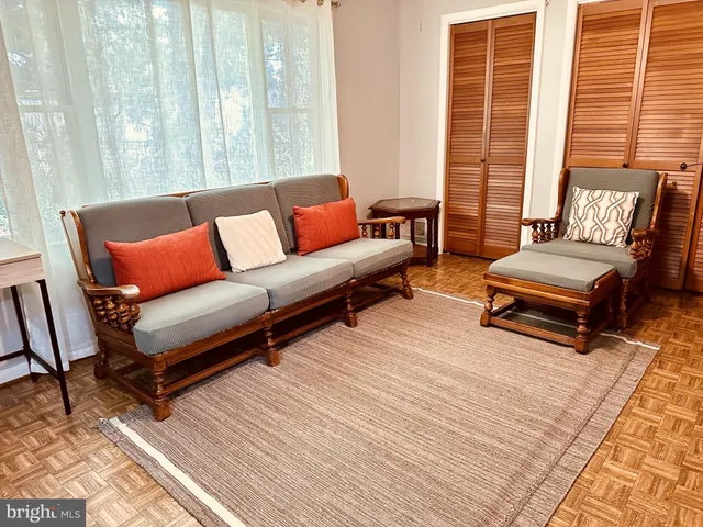 a living room with furniture and a rug