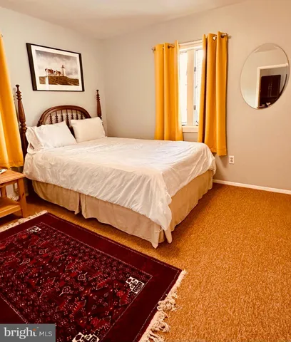 a bedroom with a bed and painting on the wall